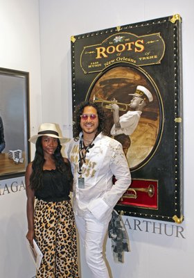 Pam Mbatani and Mago at the RJD Gallery booth with a piece by artist Jules Arthur