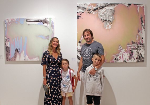 Jeff Muhs and family with his work at Roman Fine Art