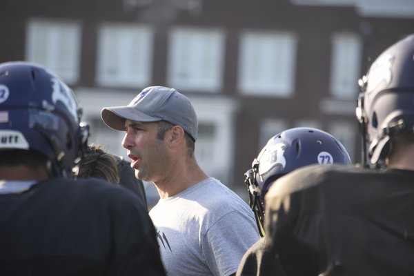 Hampton Bays head coach Rich Doulos talks to his players.