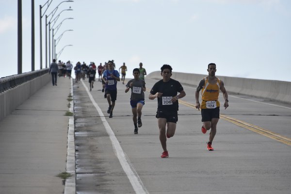 The lead runners come down Ponquogue Bridge during the ninth annual Over The Bridge 10K and 5K races.