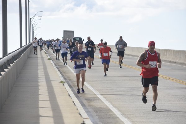 The lead runners come down Ponquogue Bridge during the ninth annual Over The Bridge 10K and 5K races.