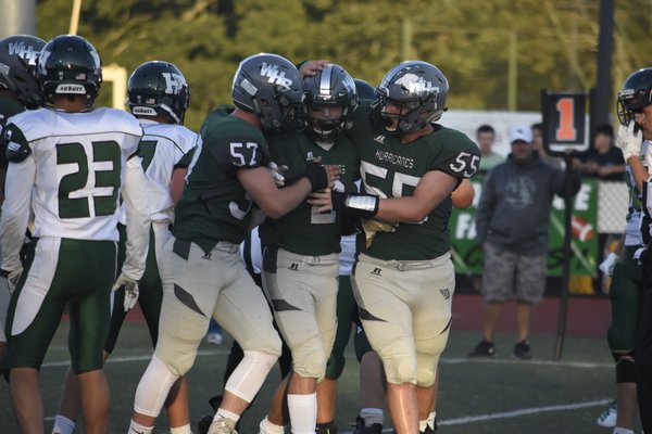 Cheis Daleo and Kevin Dillon congratulate Jaden AlfanoStJohn after he scores his and the Canes first touchdown of the season.
