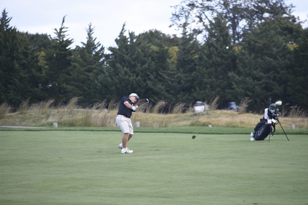 Westhampton Beach senior Cole Federico sends his ball onto the green at the first hole.