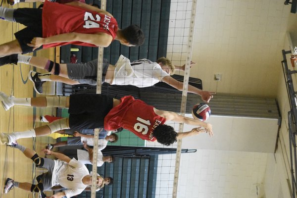 East Hampton senior Clark Miller gets a piece of the ball at the net.