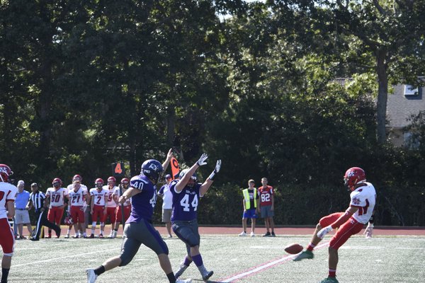 Baymen Cooper Shay (44) and Quinn Smith converge on the Center Moriches punter. Shea deflected the punt which gave his team great field position leading to its first touchdown of the season.
