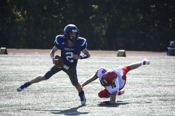 Senior quarterback Lucas Brown eludes a Center Moriches defender and breaks a long run, which was key in leading to the Baymen's first touchdown of the season.