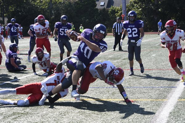 Hampton Bays senior Quinn Smith tries to break through some tackles for a touchdown but was ruled just short of the goal line. He scored on the very next play.