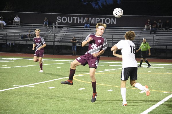 Southampton senior Ben Luss heads the ball forward and awar from his team's defensive end.
