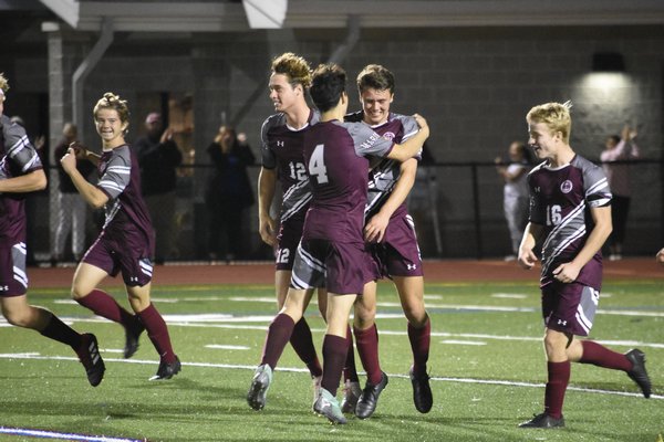 Brandon Solano (4) and other Mariners congratulate Logan Whitall for his second-half goal that gave them a 2-0 lead.