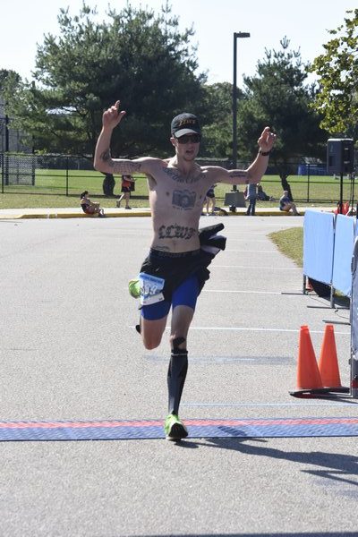 Drew Bly, 31, of New York City crosses the finish line of the Hamptons Marathon in second place.