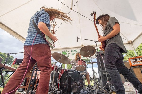 Members of The Montauk Project rock out during the Mash at Bash fundraiser event to commemorate the anniversary of Woodstock at Mashashimuet Park on Sunday afternoon.       MICAHEL HELLER