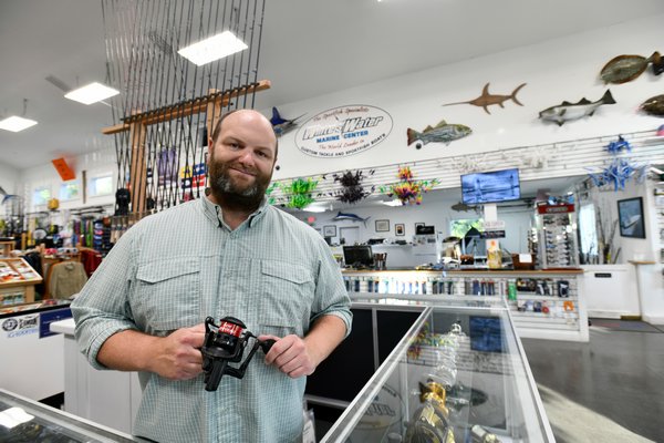 Bryce Poyer, co-owner of White Water Outfitters, in his shop in Hampton Bays.    DANA SHAW
