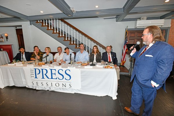 Executive Editor Joseph Shaw poses a question to the panalists at the first-ever Express News Group 