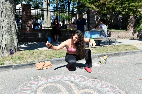 Clarisse Kahalsa works on chalk art project on Jobs Lane on Saturday.