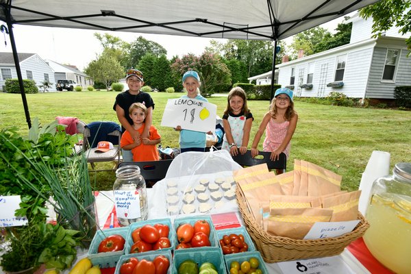 Colin DeLalio, Augie Sanicola, Lena Sanicola, Tessa DeLalio and Margaret Sanicola at their lemonade stand on Friday on North Main Street to benefit Heart of the Hamptons.   DANA SHAW