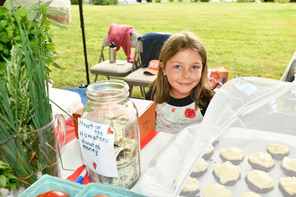 Tessa DiLalio at the lemonade stand on Friday on North Main Street to benefit Heart of the Hamptons. DANA SHAW