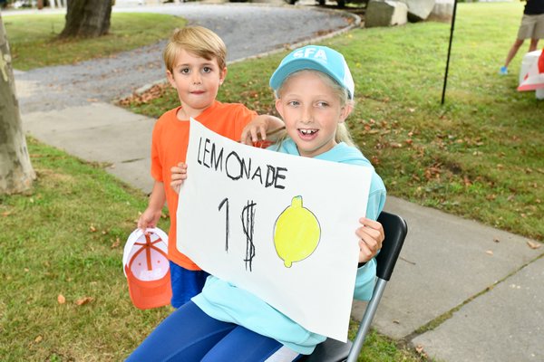 Augie and Lena Sanicola drum up business for the lemonade stand on North Main Street on Friday  to benefit Heart of the Hamptons. DANA SHAW