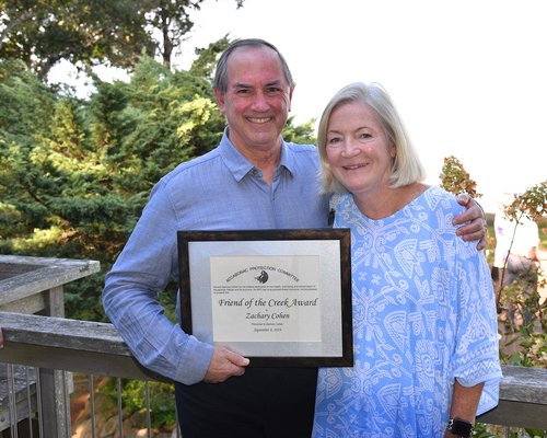 Zachary Cohen received the Friend of the Creek award at the Accabonac Protection Committee’s Summer Party on Sunday. Loring Bolger presented the award.  KYRIL BROMLEY