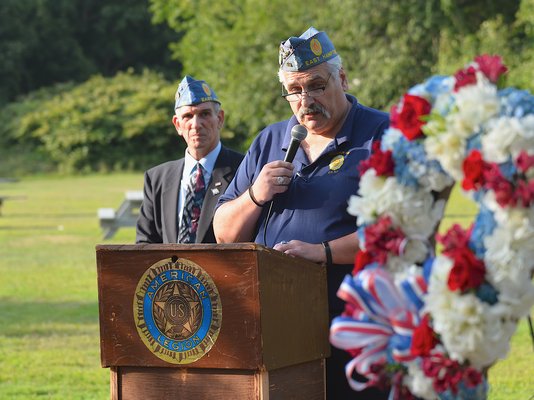 Tony Ganga speaks at the dedication of a 9/11 memorial on the grounds of the American Legion Post in Amagansett on Wednesday.    KYRIL BROMLEY