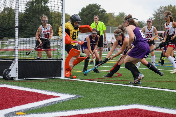 A number of Lady Baymen try to poke the ball in passed Pierson goalie Maeve O'Donoghue but come up empty.