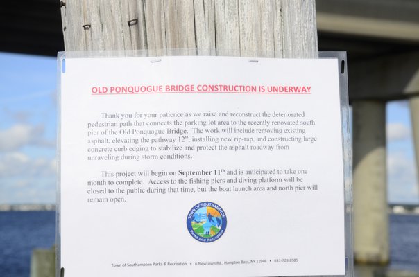 Fishermen were seen fishing on the Old Ponquogue Bridge on Friday, despite a sign noting that the pier was closed for repairs. GREG WEHNER
