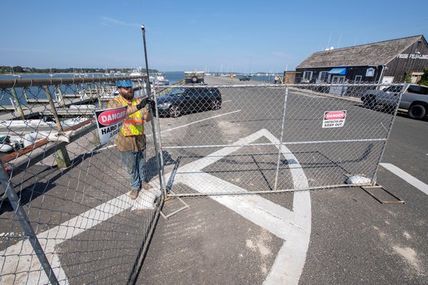 The cyclone fencing that will block off most of Long Wharf while it is being renovated over the fall and winter went up on Monday.