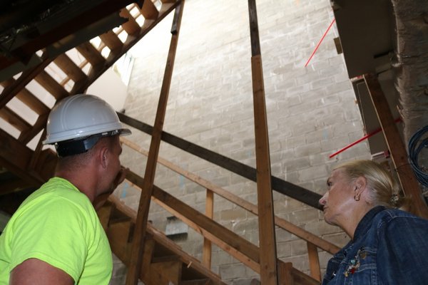 Scott Tucker and Gillian Gordon at the construction stairs in the skylight shaft that will soon be replaced by a curved staircase.