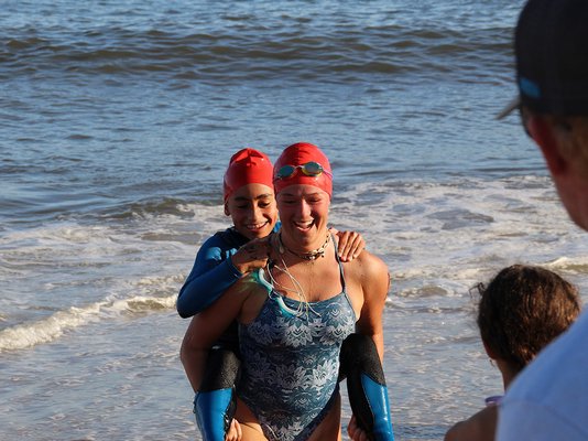 Caroline Brown and Ava Castillo have a little fun getting out of the water at Atlantic Beach.
