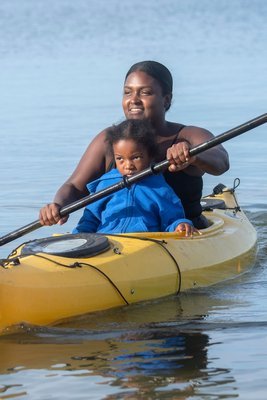 Chenae Bullock and Yeshua Shepherd paddle toward shore.   MICHAEL HELLER