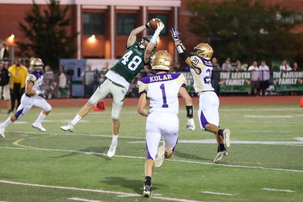 Westhampton Beach senior Aidan Cumisky goes up to catch a pass but a Sayville defender causes an incompletion.  RON ESPOSITO