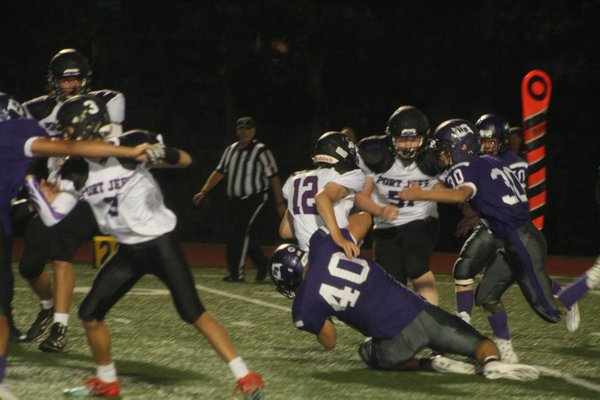 Hampton Bays senior Quinn Smith makes one of his five tackles on the night.