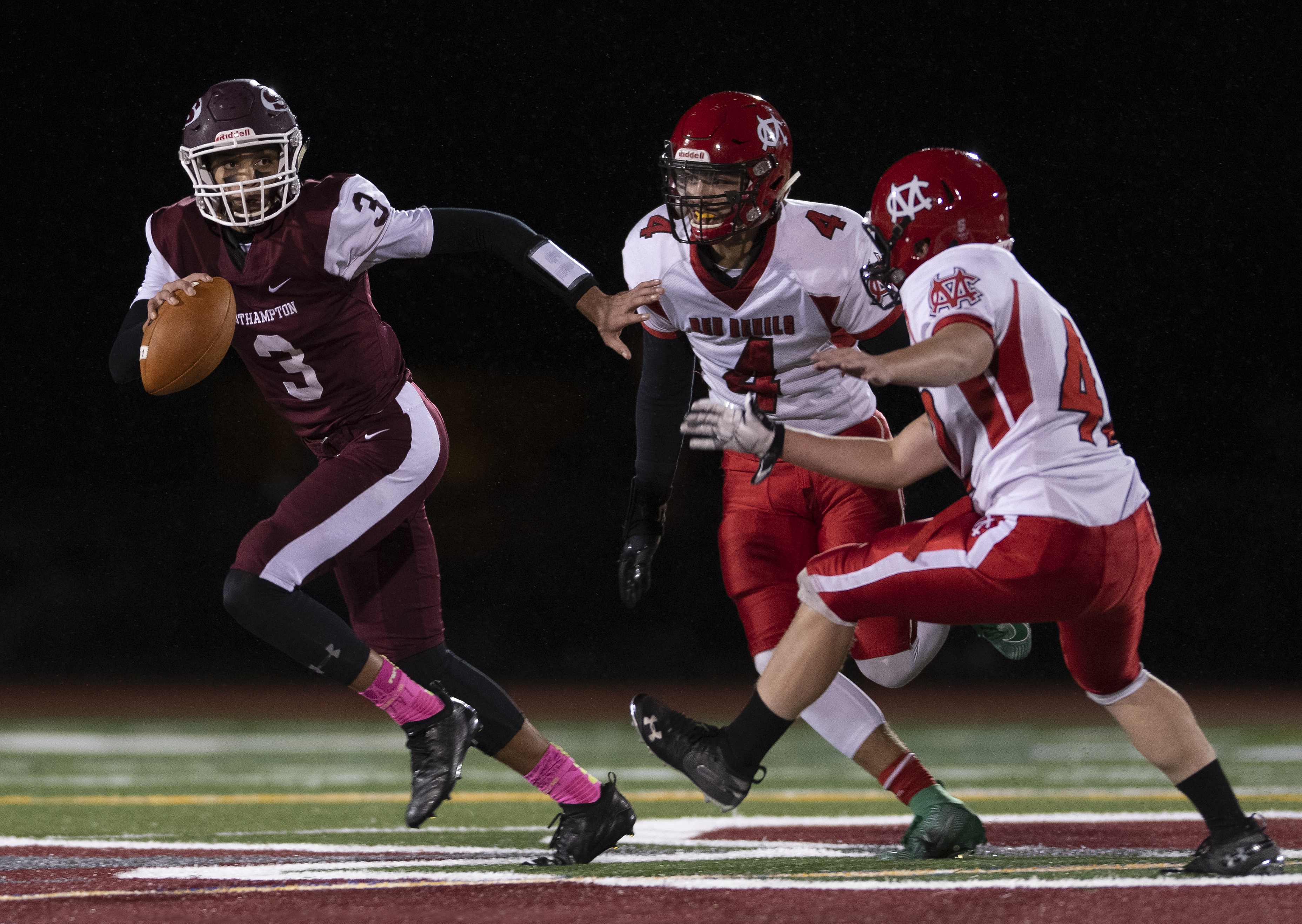 Southampton senior Dakoda Smith eludes a pair of Center Moriches defenders.