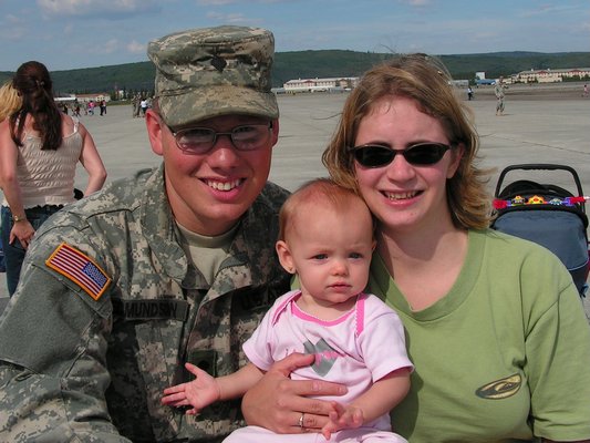 Eric Edmundson, a wounded warrior, with his wife and baby.