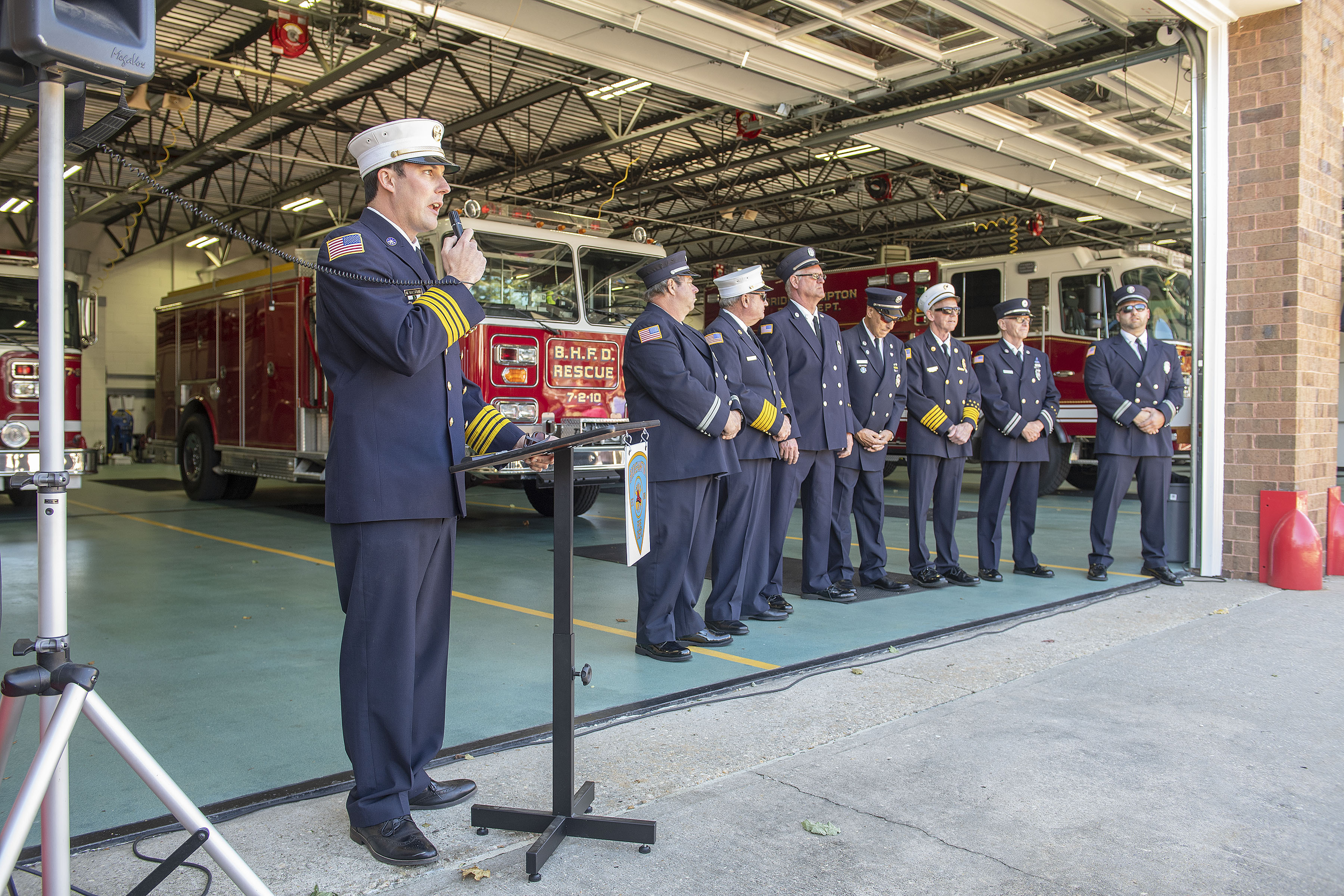 Bridgehampton Fire Department Assistant Chief Mark Balserus addresses the crowd as the Bridgehampton Fire Department hosted a Wetdown Ceremony for three new pieces of apparatus - a new Chief's pickup truck, a small, light-duty utility vehicle and a new brush truck - at their headquarters on School Street on Saturday.     MICHAEL HELLER