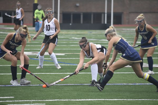 Southampton senior Morgan Fullam tries to poke the ball away from a Bayport/Blue Point player.