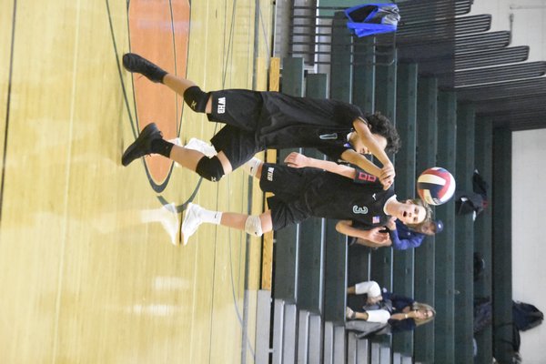 Westhampton Beach junior Carter Papagni keeps the ball from hitting the court.