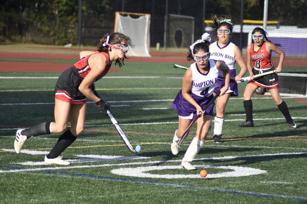 Angie Chinchilima of Hampton Bays takes the ball from Pierson's Meredith Spolarich.