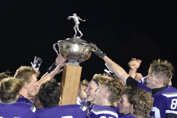 The Baymen celebrate their 29-0 victory over Southampton with the Mayor's Cup on Friday night.