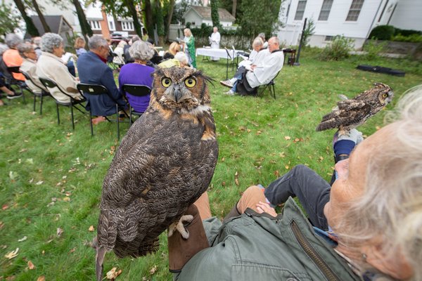 Evelyn Anderson Wildlife Rescue Center Educator Jane Gill and her great horned owl Meep wait for their turn to be blessed during the Blessing of the Animals ceremony on the great lawn of the Christ Episcopal Church in Sag Harbor on Sunday morning. MICHAEL HELLER