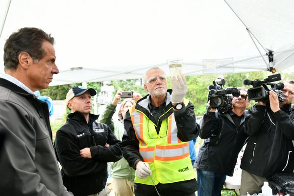 David Pinelli, left, senior scientist from Aecom, demostrates how the portable water treatment system works.   DANA SHAW
