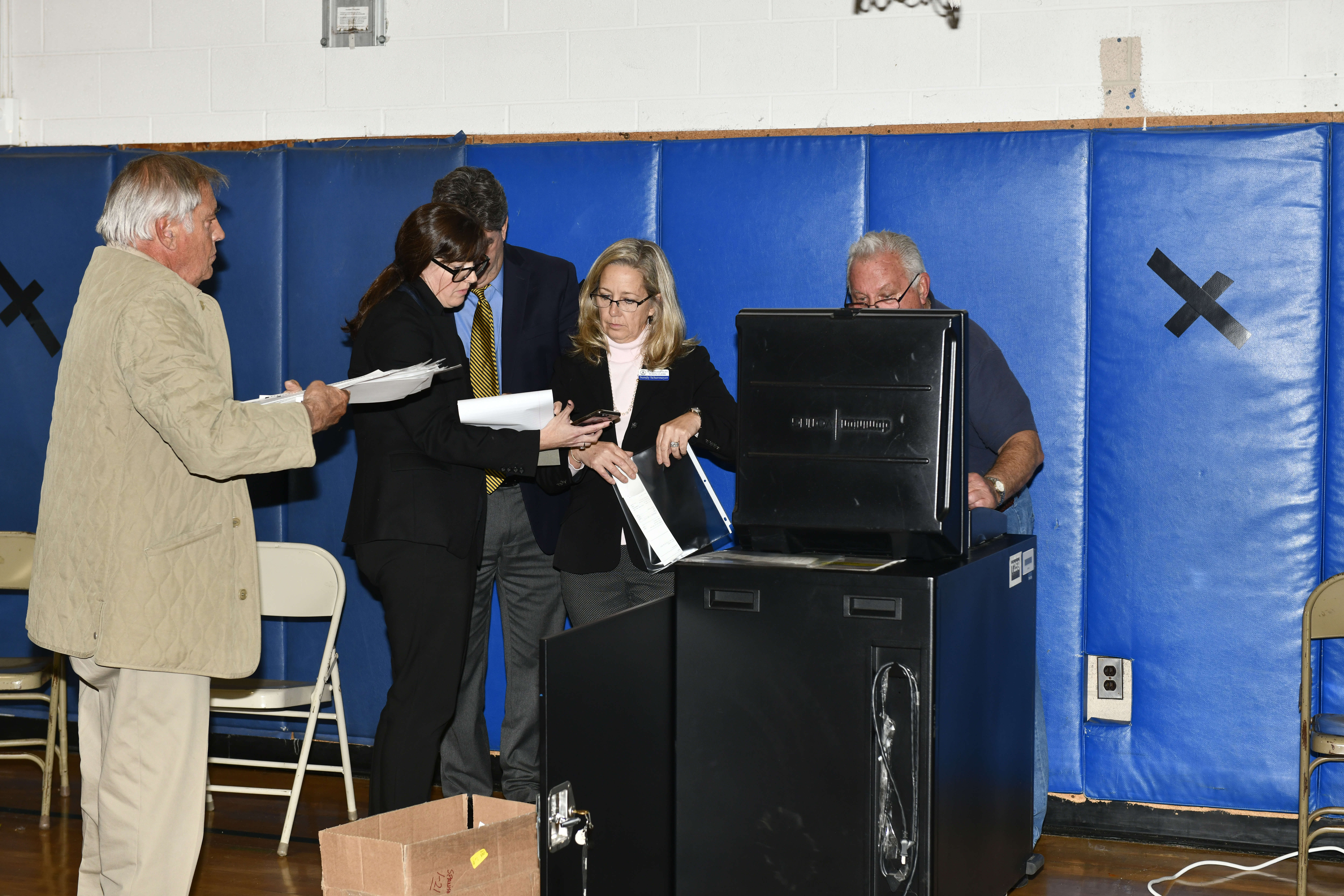 The votes are compiled at East Quogue School on Thursday night.    DANA SHAW