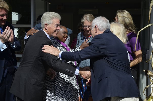 Suffolk County Executive Steve Bellone and Southampton Town Supervisor Jay Schneiderman shake hands after cutting the ribbon for the new Sandy Hollow Cove Apartments in Tuckahoe. ANISAH ABDULLAH