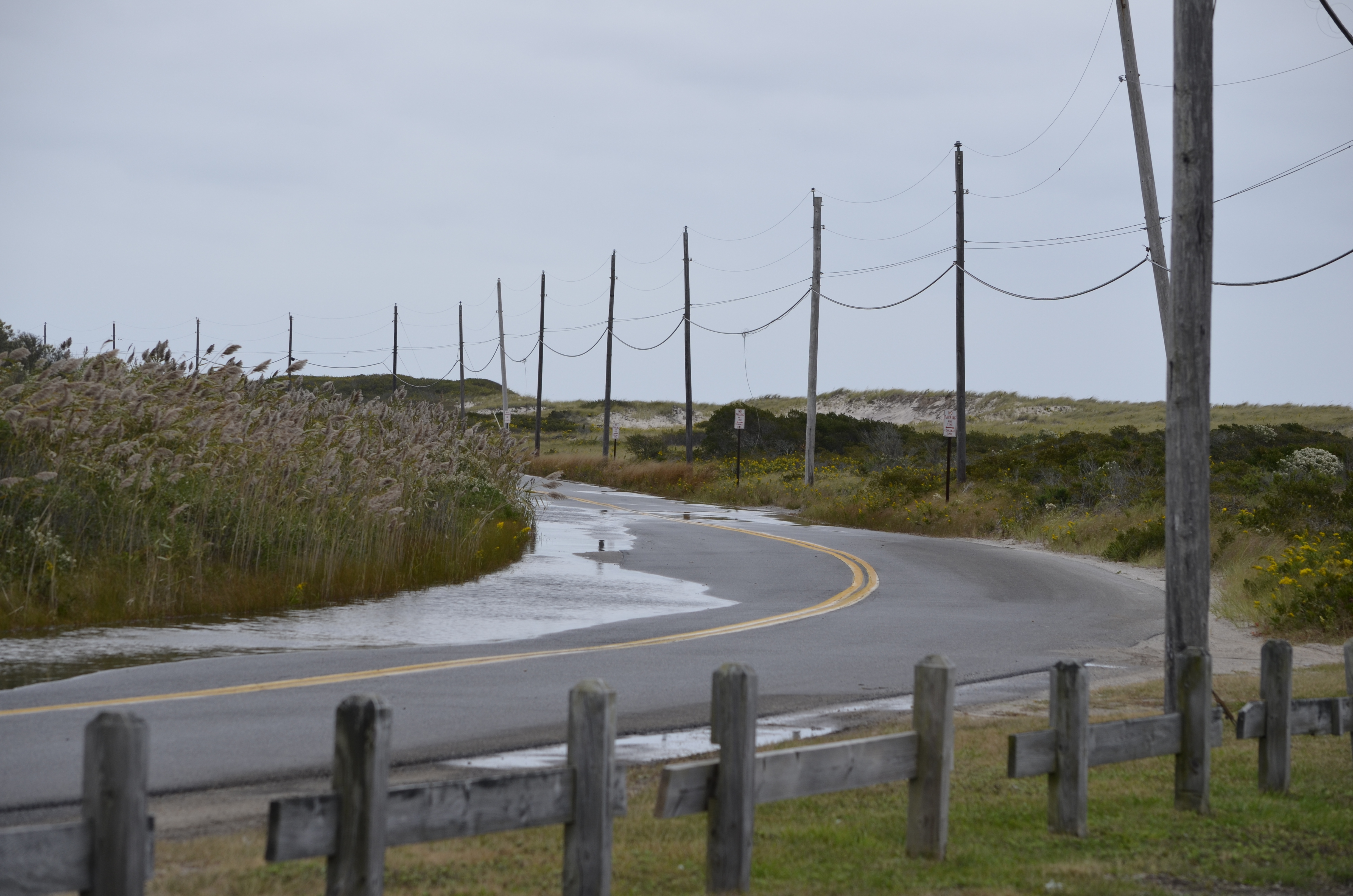 Some flooding on Dune Road was visible from the Ponquogue Beach parking lot. ANISAH ABDULLAH