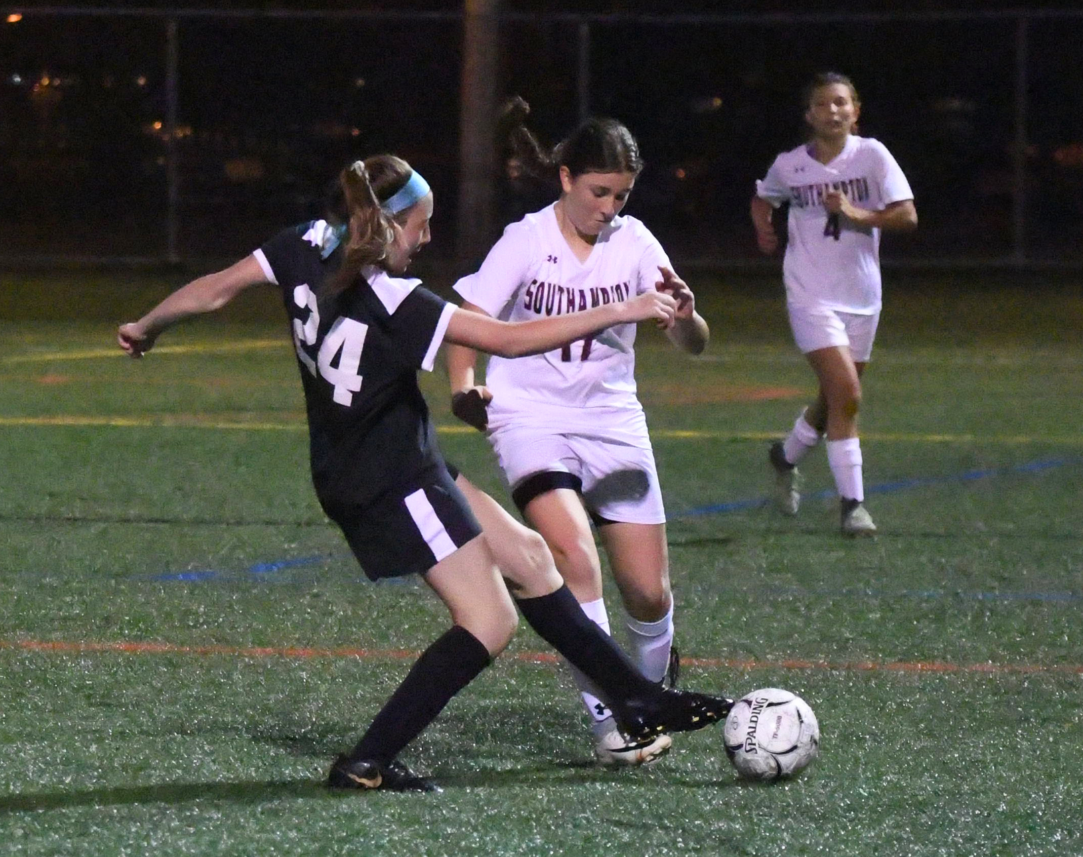 Babylon defender Brooke Gengler pokes the ball away from Southampton's Ellie Avallone along the left sideline.