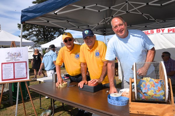 The Montauk Lions Club sponsored a Crafts Fair on the Montauk Green on Saturday and Sunday, drawing a variety of craftspeople and buyers. Lions Leon Day, Rich Schoen and John Ward at the raffle table. KYRIL BROMLEY