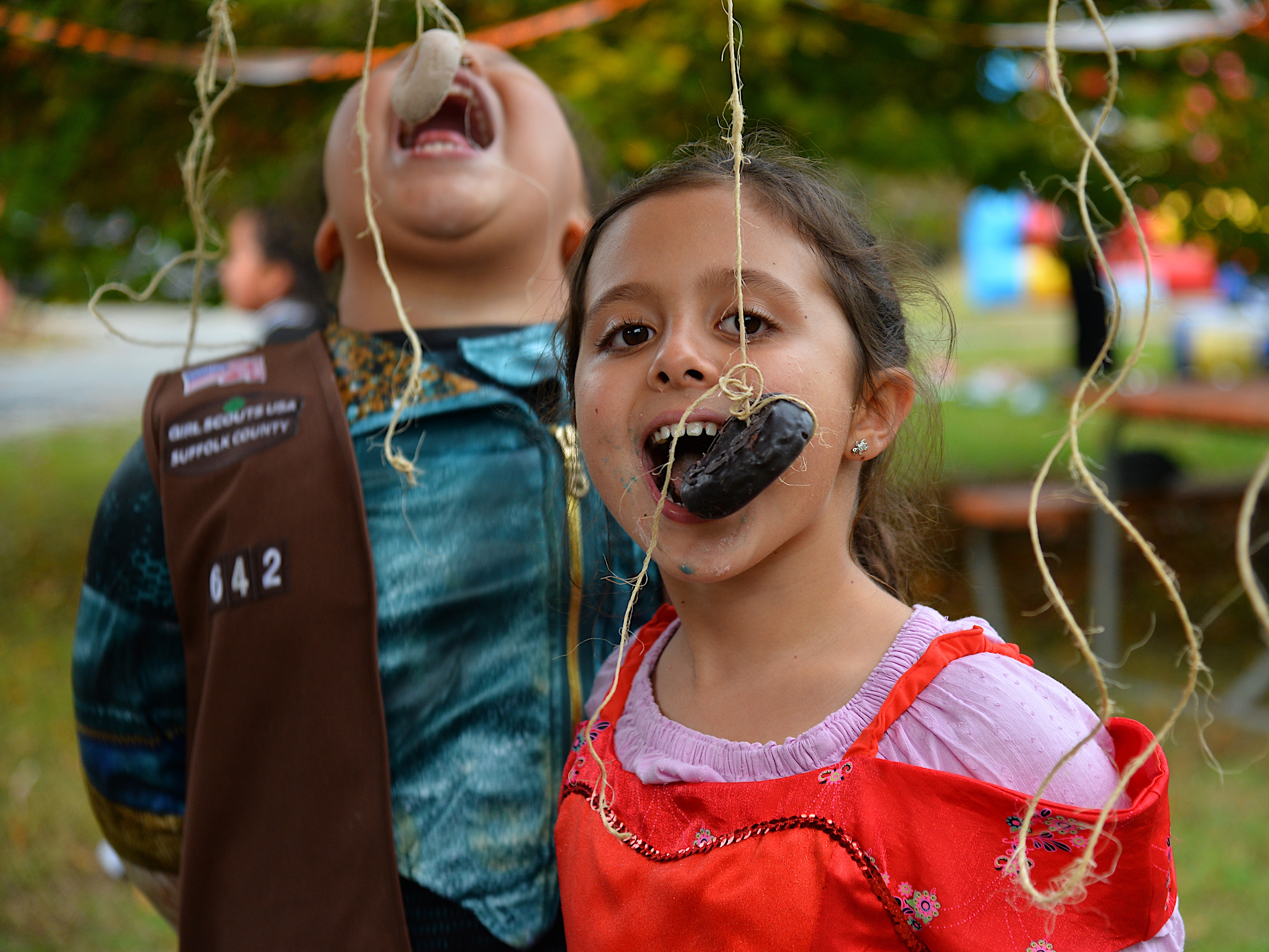 The Bridgehampton Child Care and Recreational Center hosted a Halloween party on Friday afternoon, during which Kellis Quinn and Maya McDonald angled for donuts. KYRIL BROMLEY