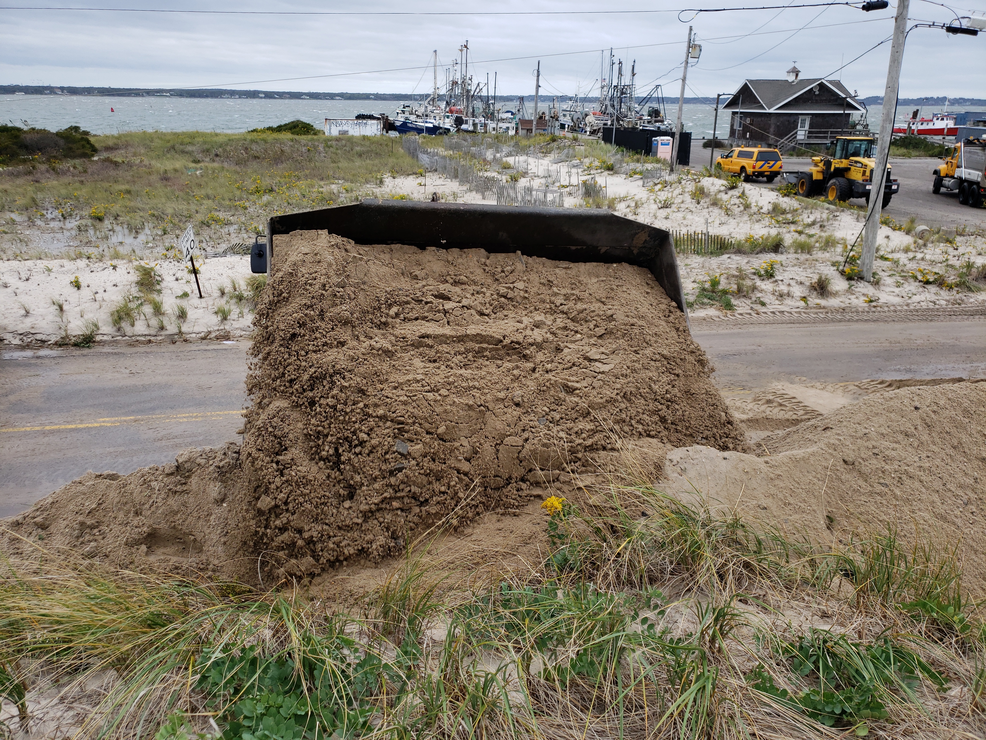 County and state crews helped rebuild a nearly 100-yard dune that was breached during a nor'easter on Thursday night. GREG WEHNER