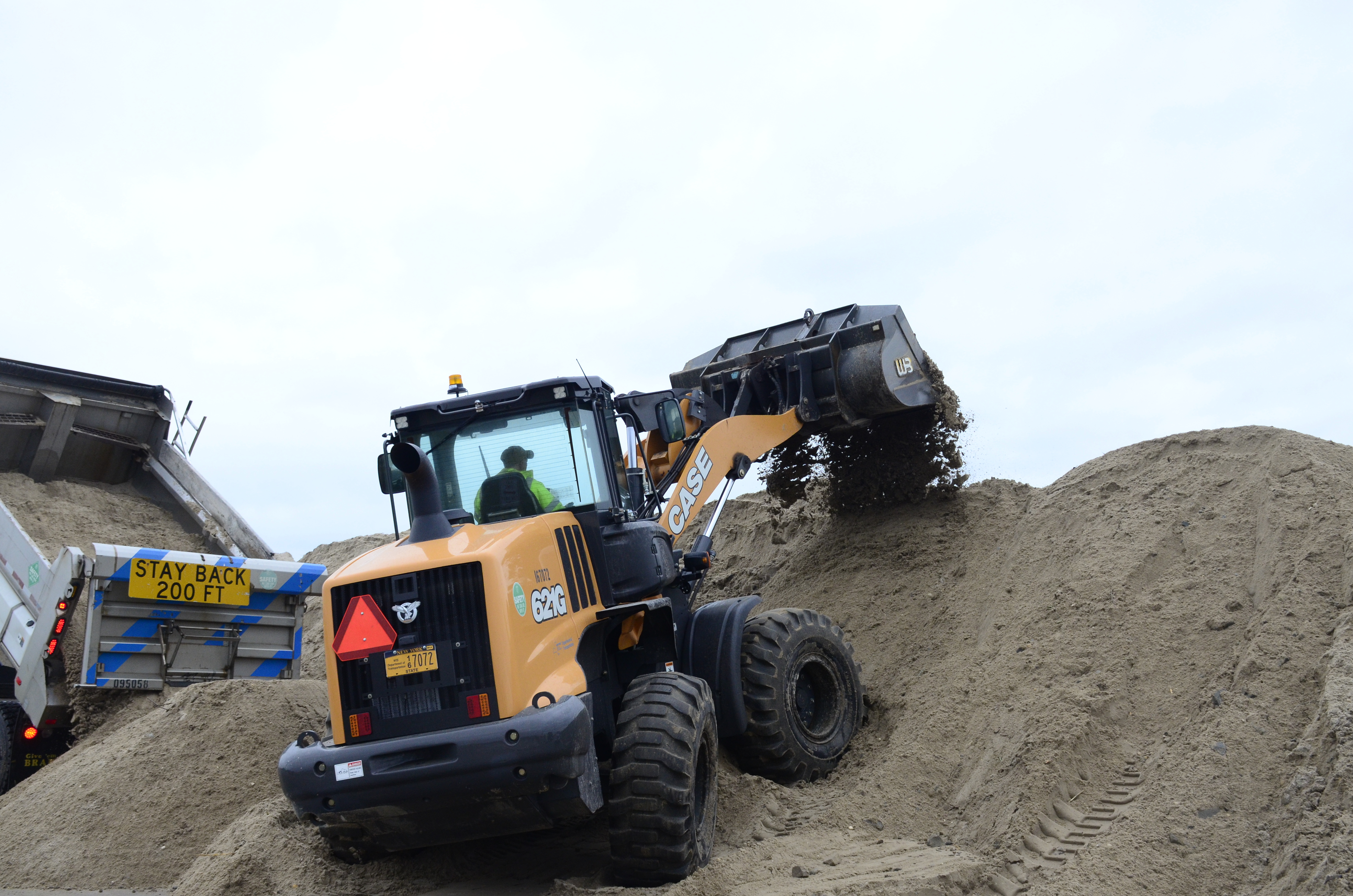 County and state crews helped rebuild a nearly 100-yard dune that was breached during a nor'easter on Thursday night. GREG WEHNER