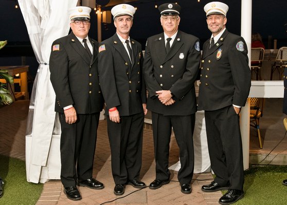 The Southampton Town Fire Chiefs Council honored East End firefighters and EMTs of the year at a dinner at Dockers restaurant in East Quogue on Saturday. The Hampton Bays Firefighter of the Year was Michael Zarro. From left, Hampton Bays First Assistant Chief Christian Hansen, Chief Bowman Prendergast, Mr.  Zarro, and Third Assistant Chief Rick Nydegger Courtesy Westhampton Beach Fire Department