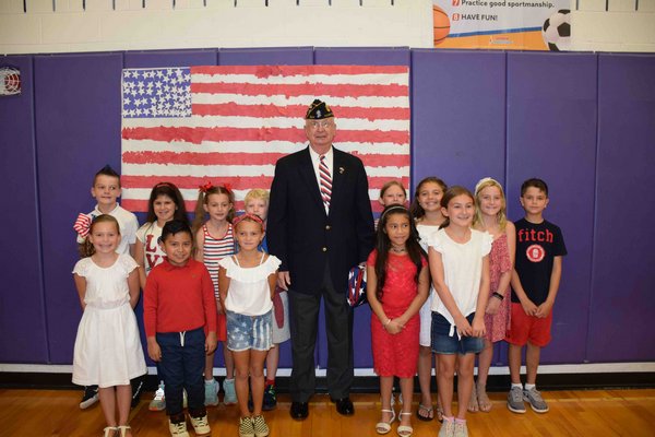 Hampton Bays School District flew the American flag in September in honor of local veteran Richard Mongiello Sr.